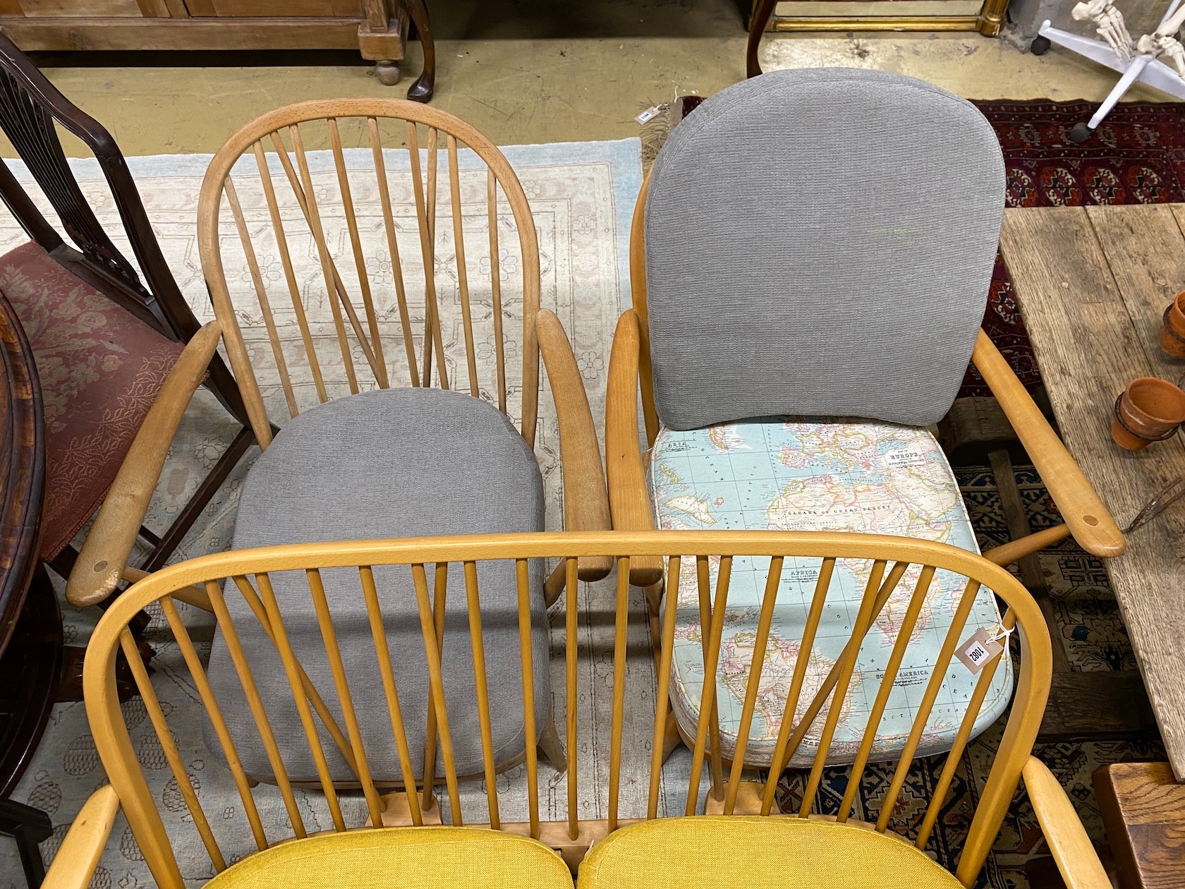 A mid century Ercol light beech three piece lounge suite, lacks three back cushions, settee length 133cm, depth 76cm, height 78cm